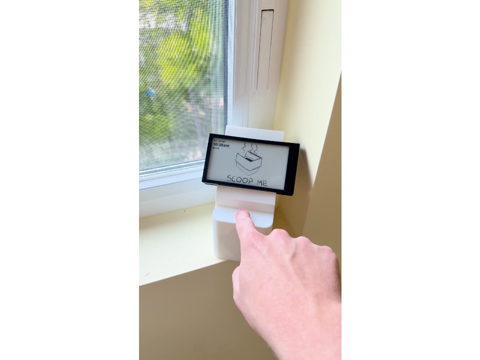 E-ink litter reminder and its physical button mounted by a window