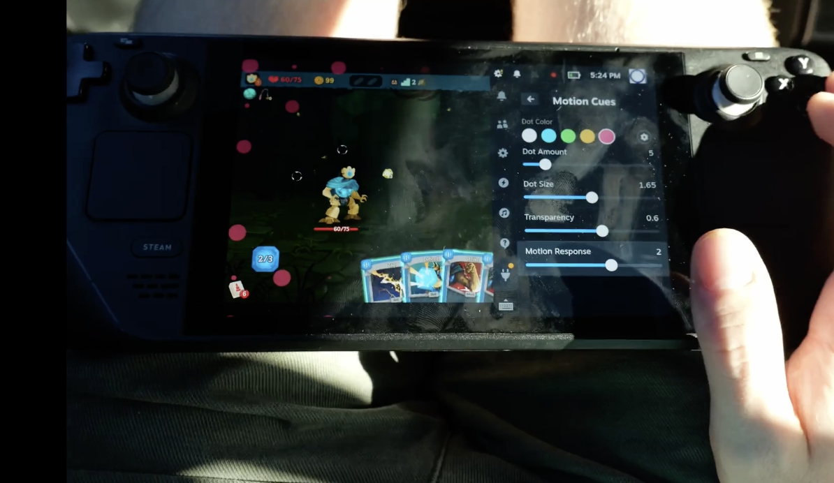 Steam Deck running a game with pink motion cue dots and the Motion Cues settings panel